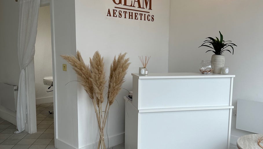 Reception area of GLAM AESTHETICS- HALLE in Sidcup, England. Minimalist design with pampas grass and plants.