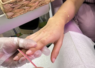 Manicure at Purple Nail Spa in Riyadh, Riyadh Province, SA. Technician carefully shaping nails.