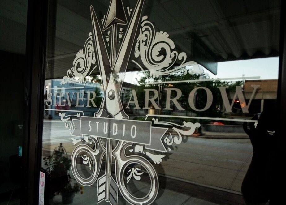 Entrance glass with Silver Arrow Studio logo at Tasha Foster's in Dixon, Illinois, US.