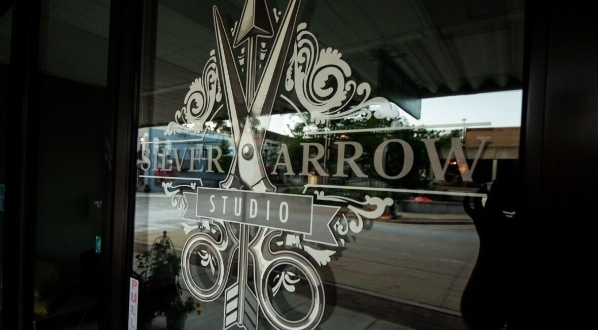 Entrance glass with Silver Arrow Studio logo at Tasha Foster's in Dixon, Illinois, US.