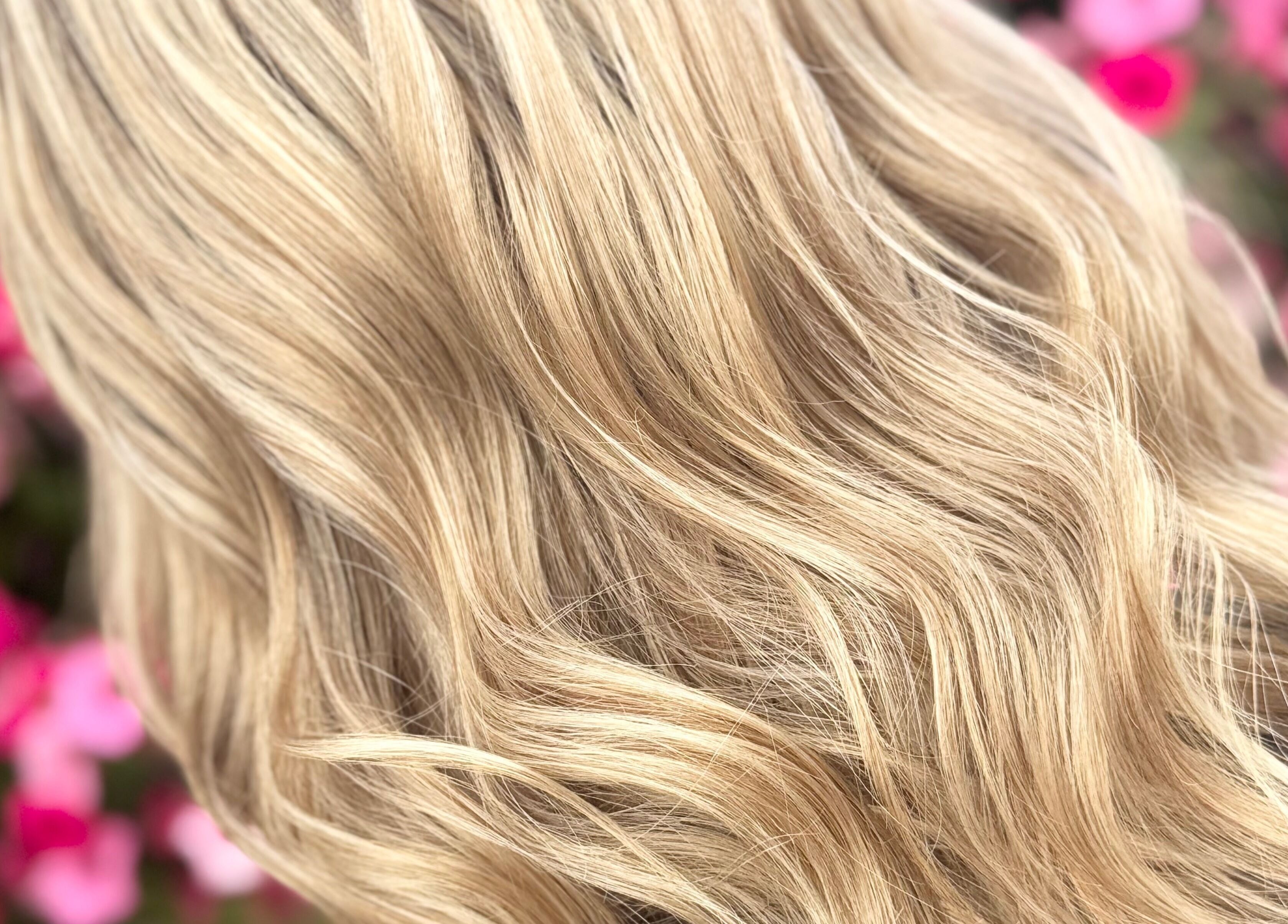 Close-up of blonde wavy hair styled at Tasha Foster - Silver Arrow Studio, Dixon, Illinois, US.