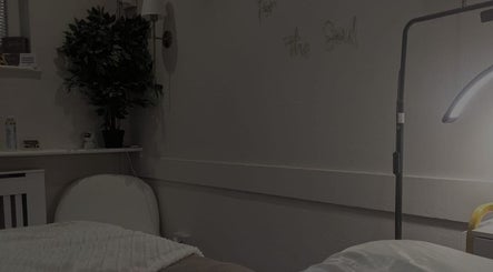 Cozy therapy room at Pro-Motion Sports Therapy in Crawley, England, GB, featuring a comfortable bed and warm lighting.