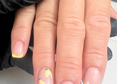 Stylish lemon-themed nail design at No4Beauty in Sandy, England, GB showcasing vibrant yellow accents.