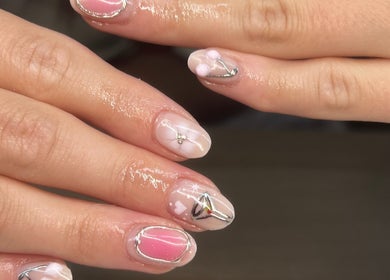 Intricate nail art at No4Beauty, Sandy, England, GB. Features delicate designs in soft pink and white tones.