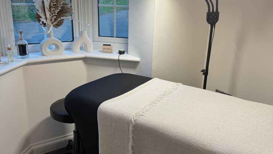 A cozy wellness treatment room at The Lash Box, Bristol, England, GB, with a bed and minimal decor.