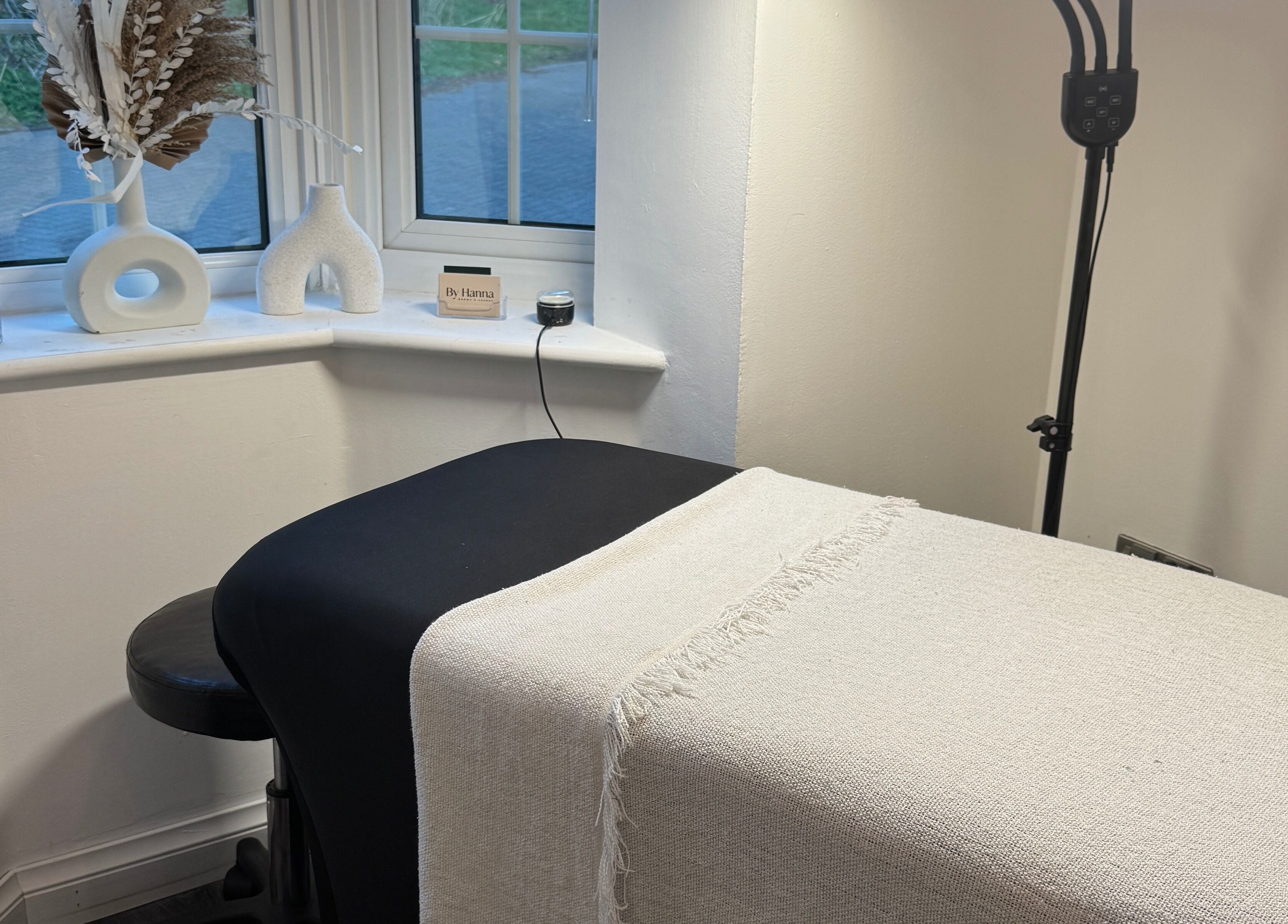 A cozy wellness treatment room at The Lash Box, Bristol, England, GB, with a bed and minimal decor.