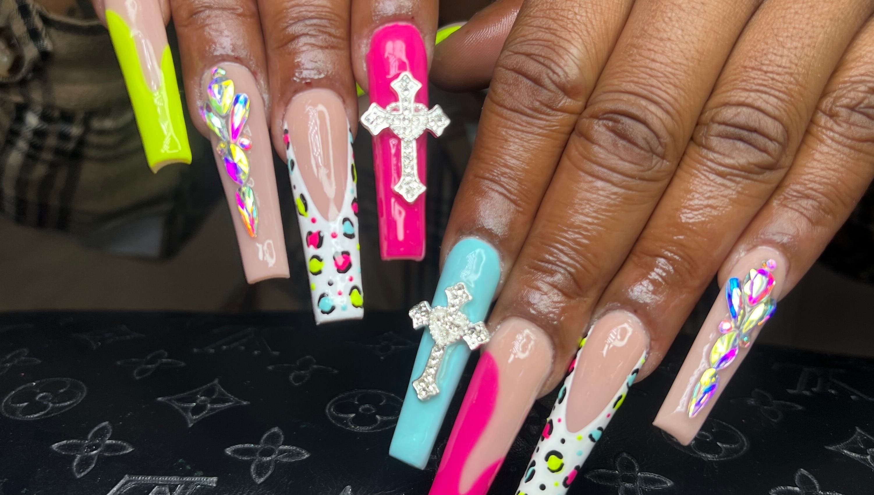 Intricate nail art with vibrant colors and gems at Raveen at Bare Skin&Spa, Columbia, South Carolina, US.