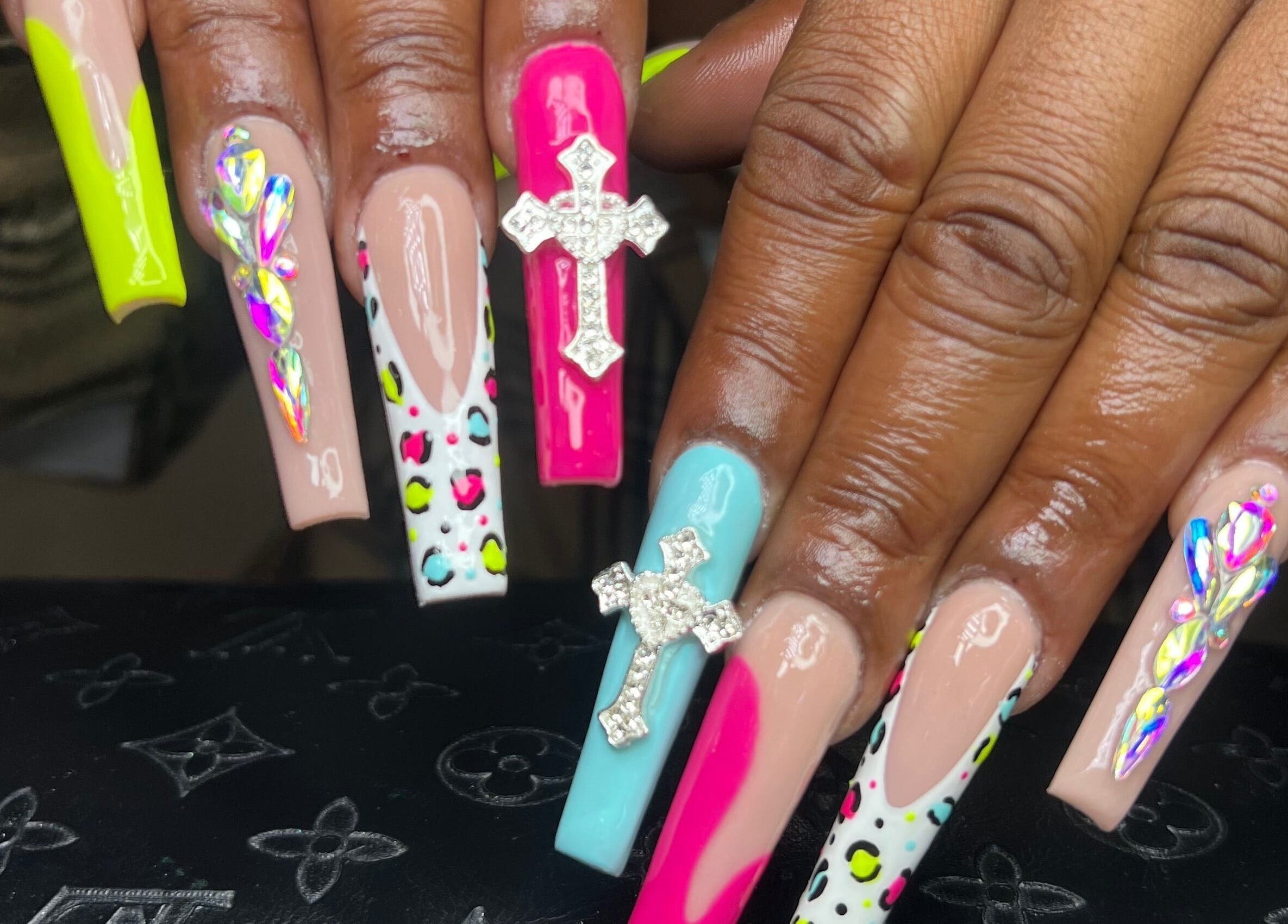 Intricate nail art with vibrant colors and gems at Raveen at Bare Skin&Spa, Columbia, South Carolina, US.