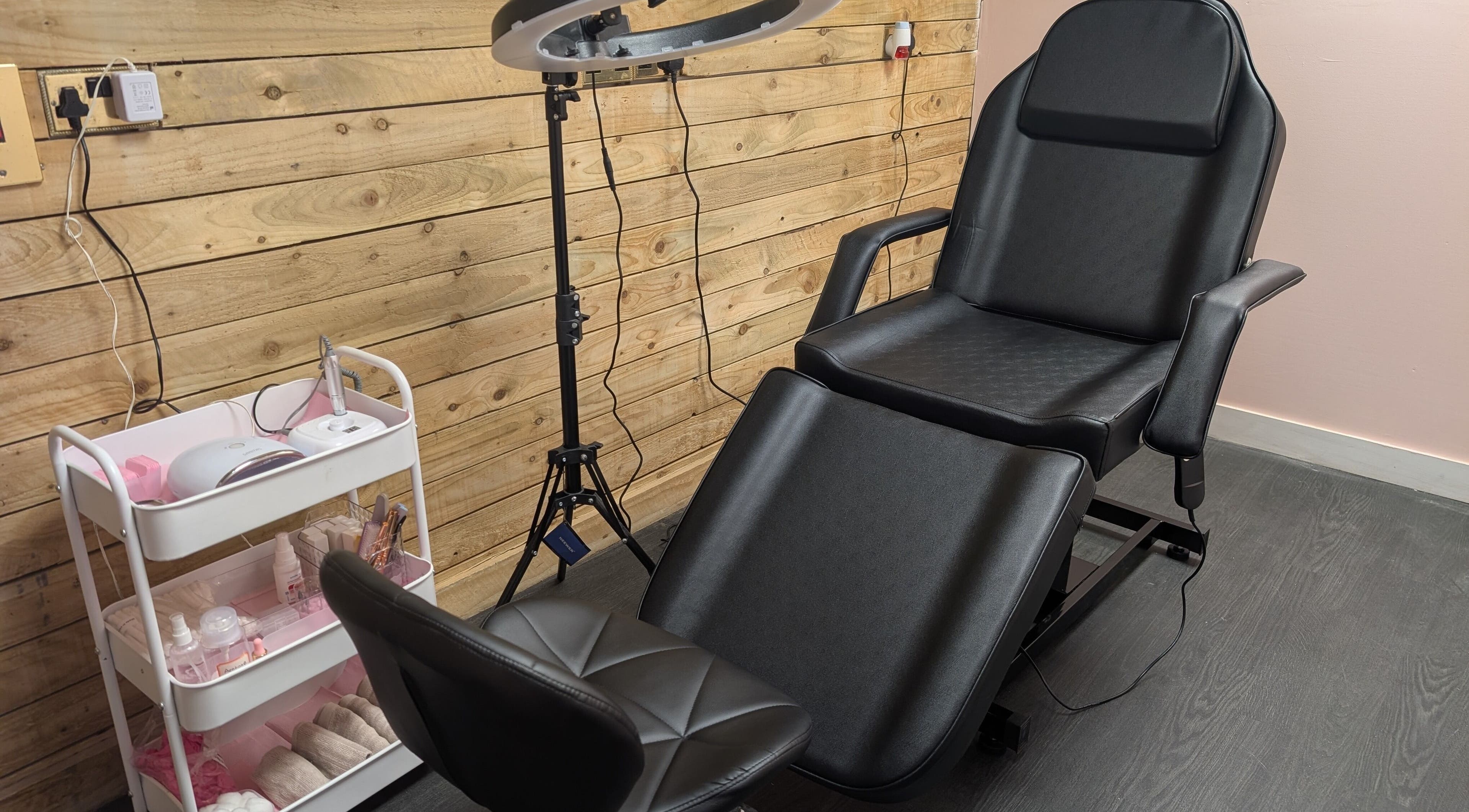 Ona's modern beauty setup in Tonna, Wales, GB with a sleek chair and styled equipment.