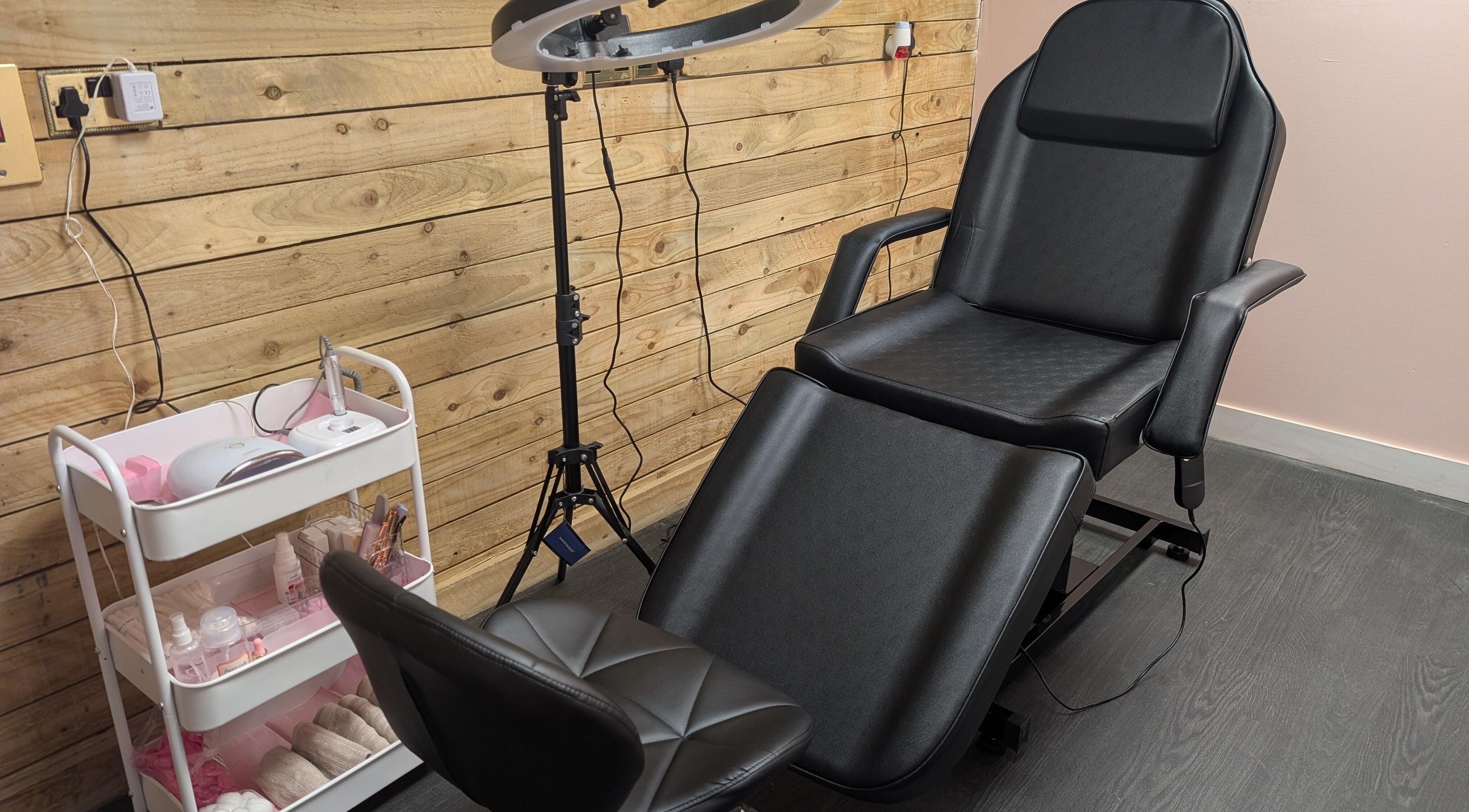 Ona's modern beauty setup in Tonna, Wales, GB with a sleek chair and styled equipment.