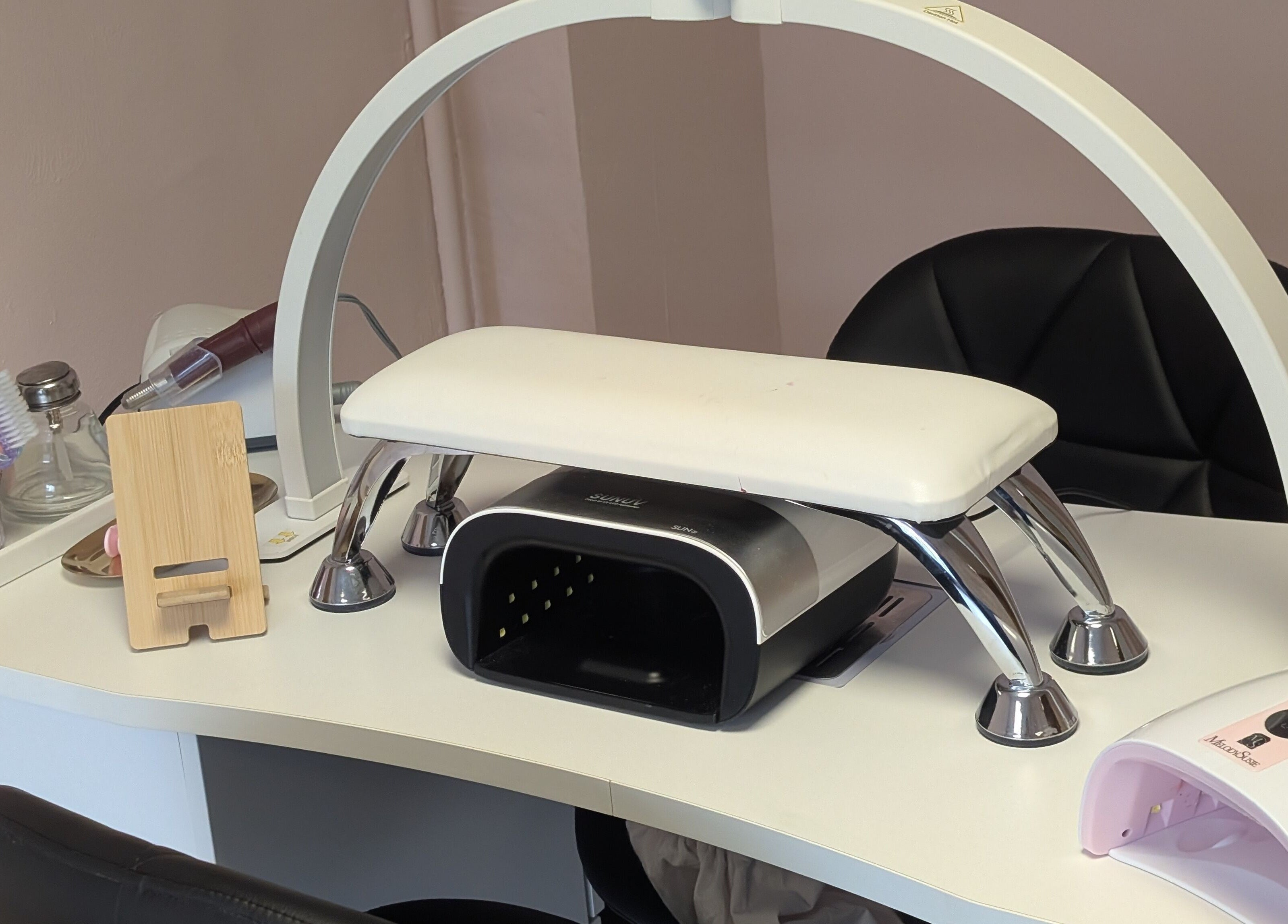 Manicure station with tools at Ona, Tonna, Wales, GB, showcasing a clean and welcoming nail salon setup.