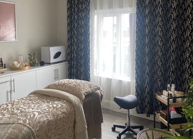 Cozy treatment room at Beauty Magic, Malvern, England, GB with plush bedding and elegant decor.