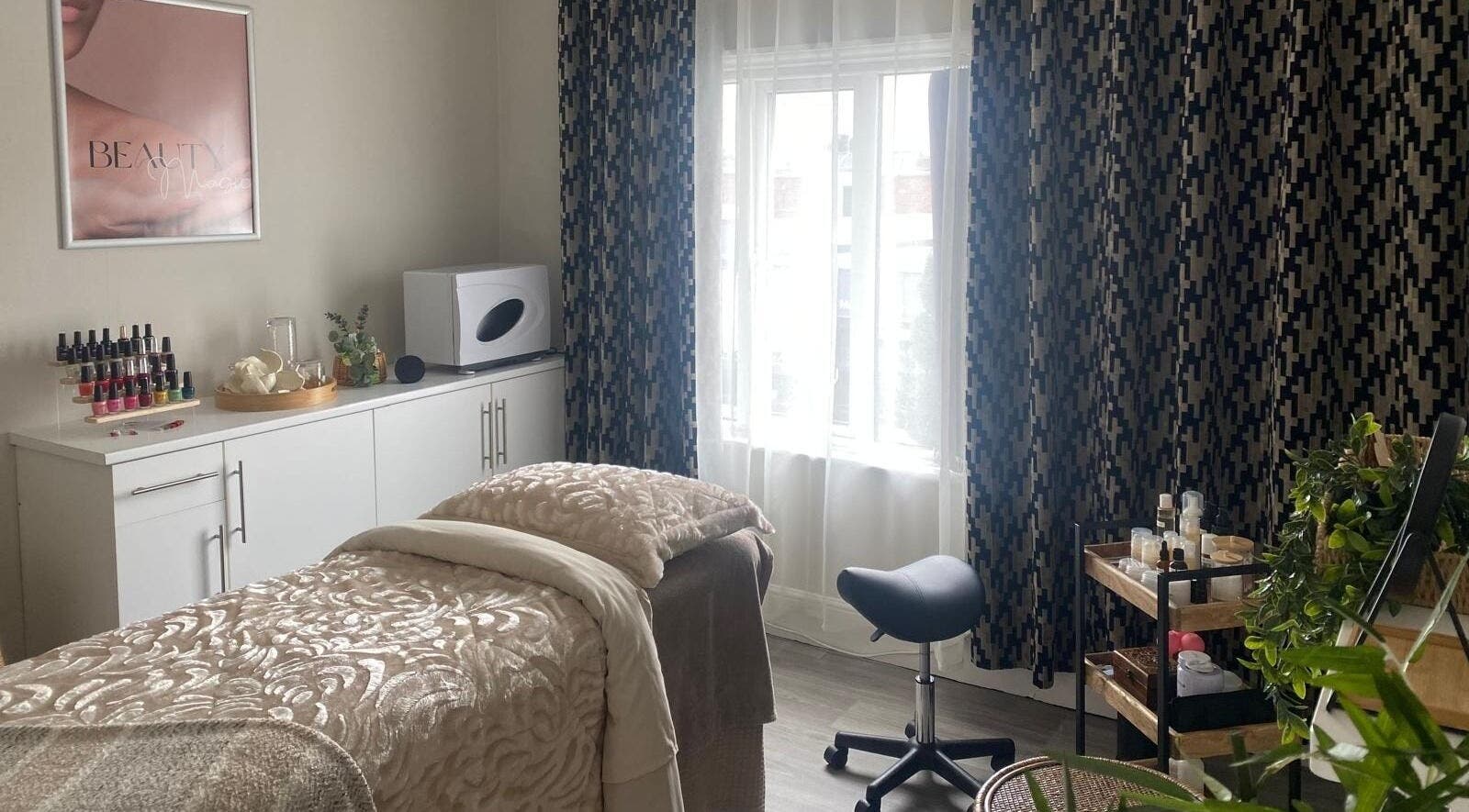 Cozy treatment room at Beauty Magic, Malvern, England, GB with plush bedding and elegant decor.