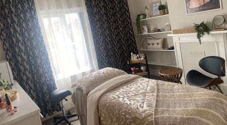 Relaxing treatment room at Beauty Magic, Malvern, England, GB with cozy bed and elegant decor.