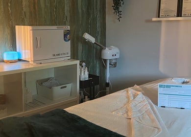 Cozy treatment room at Libertys Wellness Retreat, Melton Mowbray, England with a massage table and equipment.