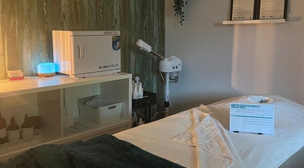 Cozy treatment room at Libertys Wellness Retreat, Melton Mowbray, England with a massage table and equipment.