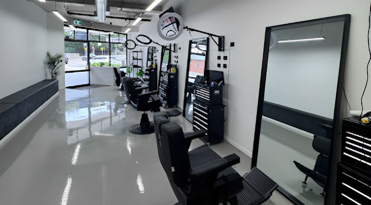 Modern interior of Elevate Barber Studio in Stanmore, New South Wales, AU showcasing sleek chairs and mirrors.