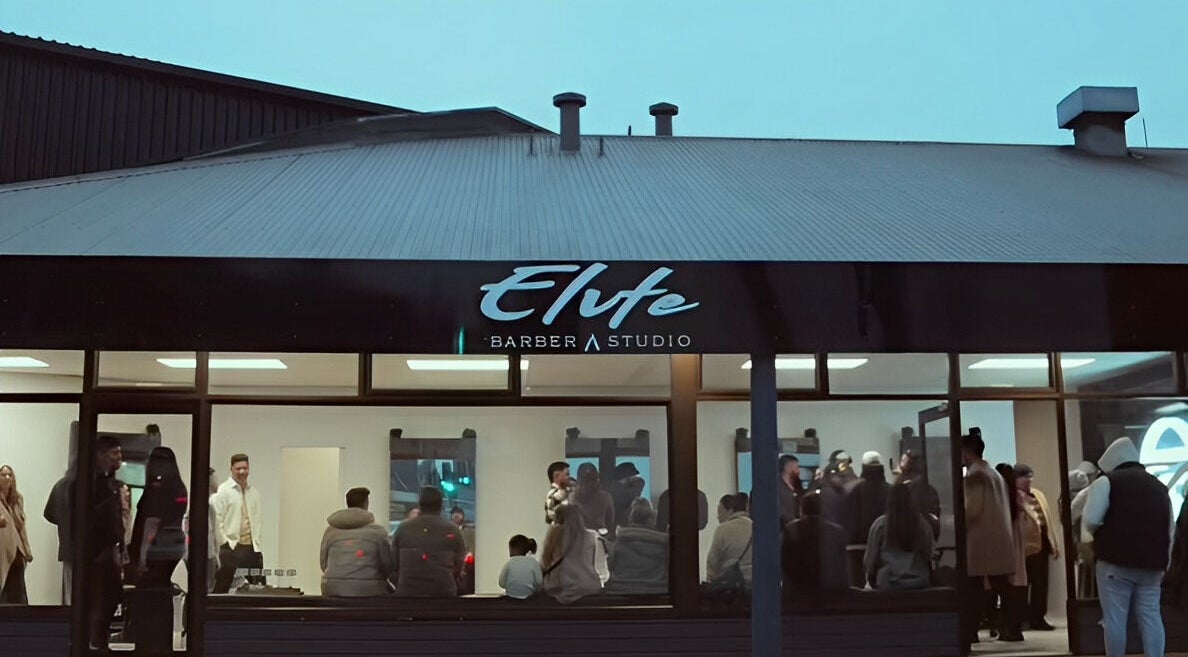 Evening view of Elevate Barber Studio in Stanmore, New South Wales, AU, bustling with patrons.