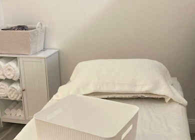 Massage room at Mina Beauty & Massage in Mermaid Beach, Queensland, AU with white linens and soft towels.
