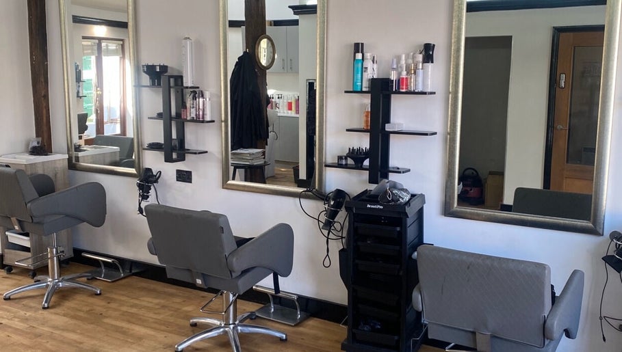 Modern salon chairs and mirrors at Emma Dixon Hair in Bury St Edmunds, England, GB.