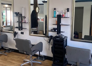 Modern salon chairs and mirrors at Emma Dixon Hair in Bury St Edmunds, England, GB.