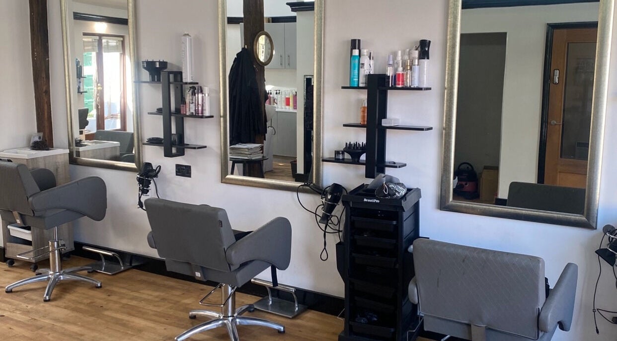 Modern salon chairs and mirrors at Emma Dixon Hair in Bury St Edmunds, England, GB.