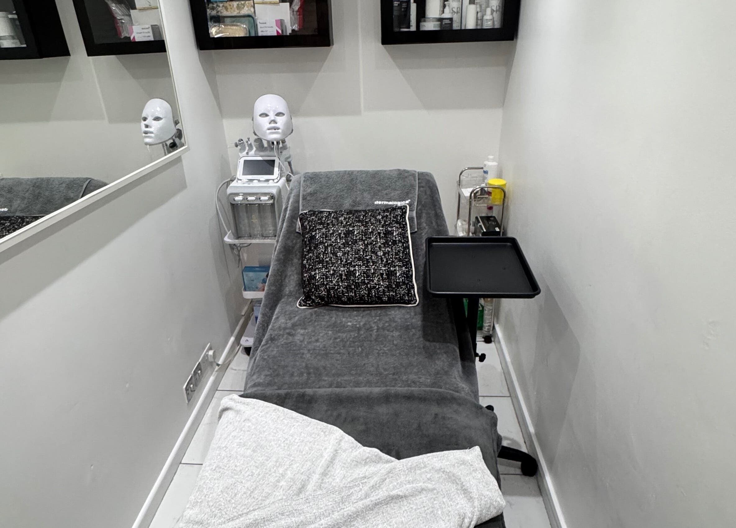 Therapy room at EnhancedwithKay, London, England, GB, featuring treatment bed and equipment.