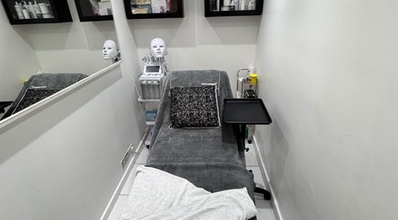 Therapy room at EnhancedwithKay, London, England, GB, featuring treatment bed and equipment.