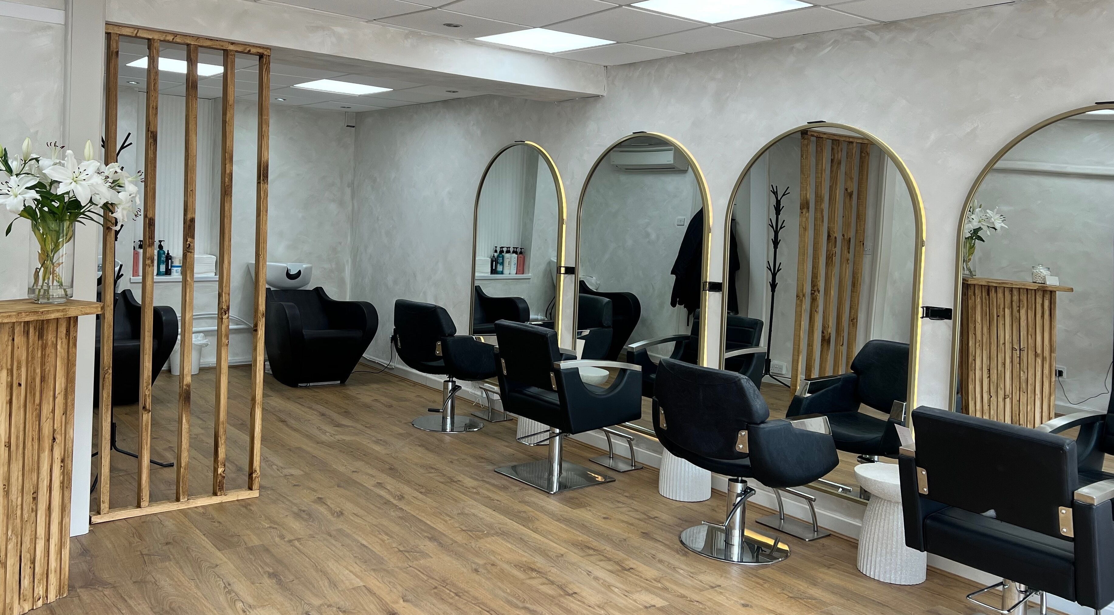 Sophisticated salon chairs and mirrors at Rossa Hair, Nailsea, England, GB with stylish decor and lighting.