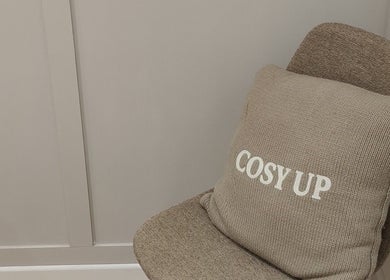 Comfortable chair with 'cosy up' cushion at Serenity & Wellness Therapies, Par, England, GB.