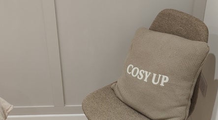 Comfortable chair with 'cosy up' cushion at Serenity & Wellness Therapies, Par, England, GB.