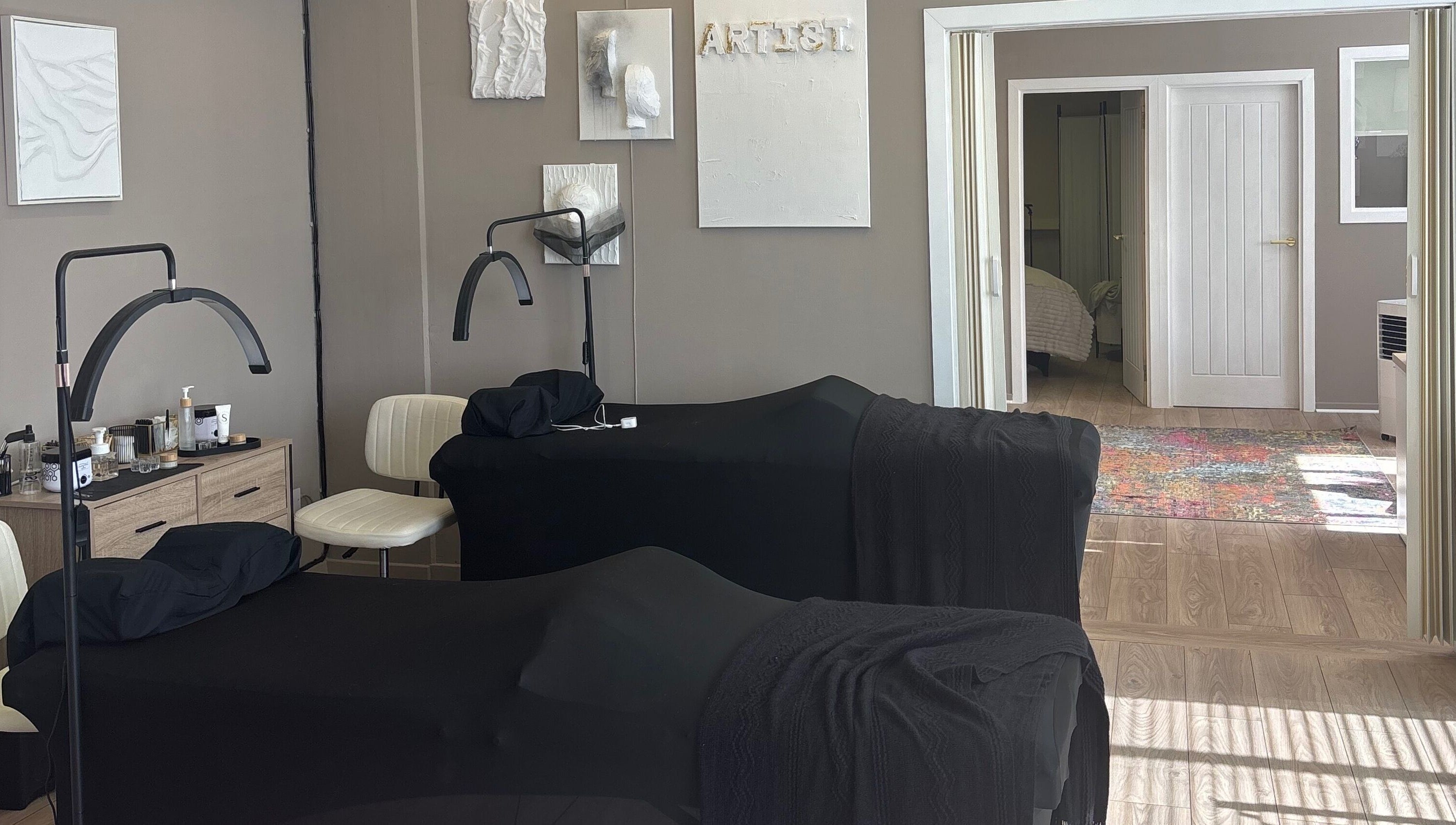 Relaxing treatment room at Carved by Chloe, Livingston, Scotland, GB with massage tables and soothing decor.