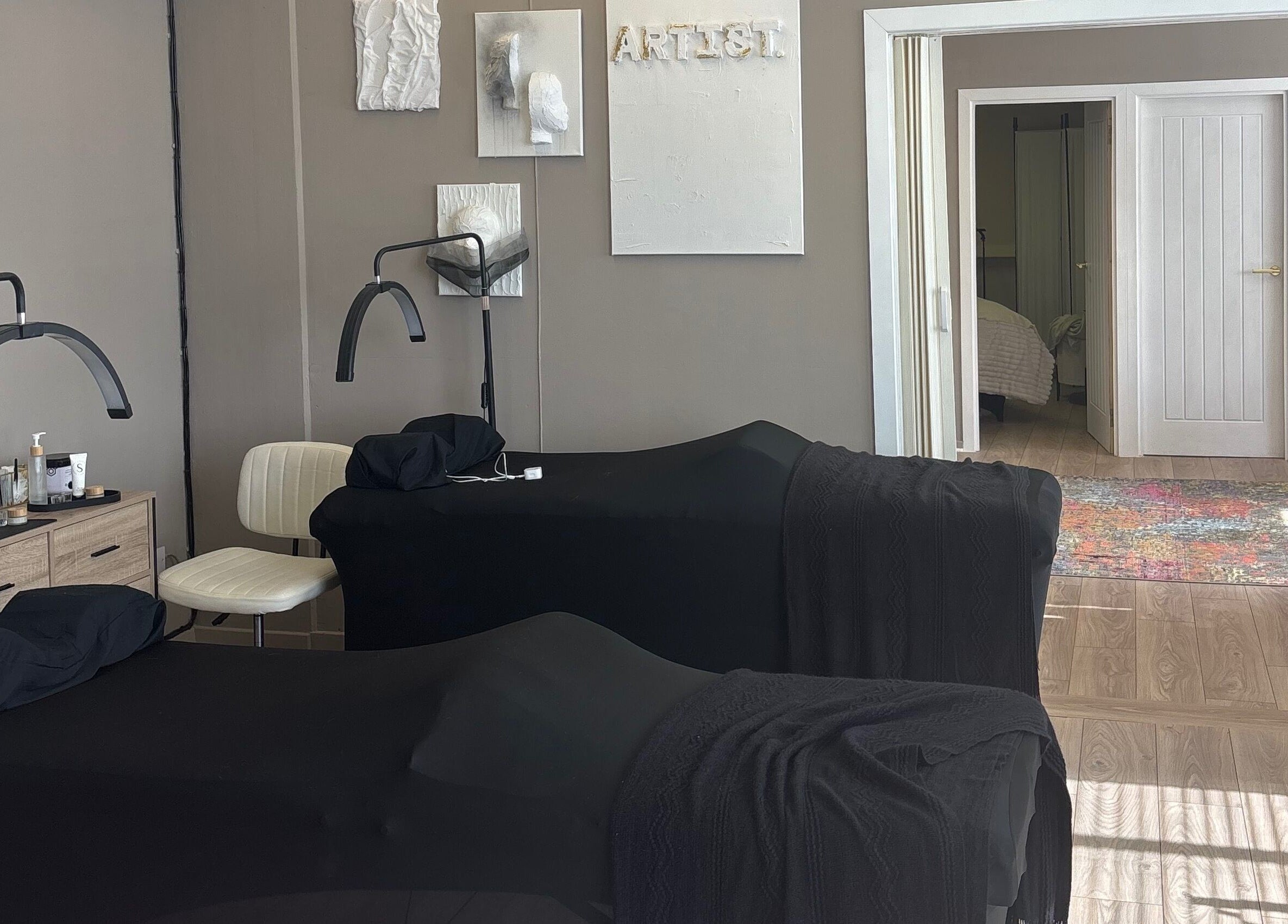 Relaxing treatment room at Carved by Chloe, Livingston, Scotland, GB with massage tables and soothing decor.