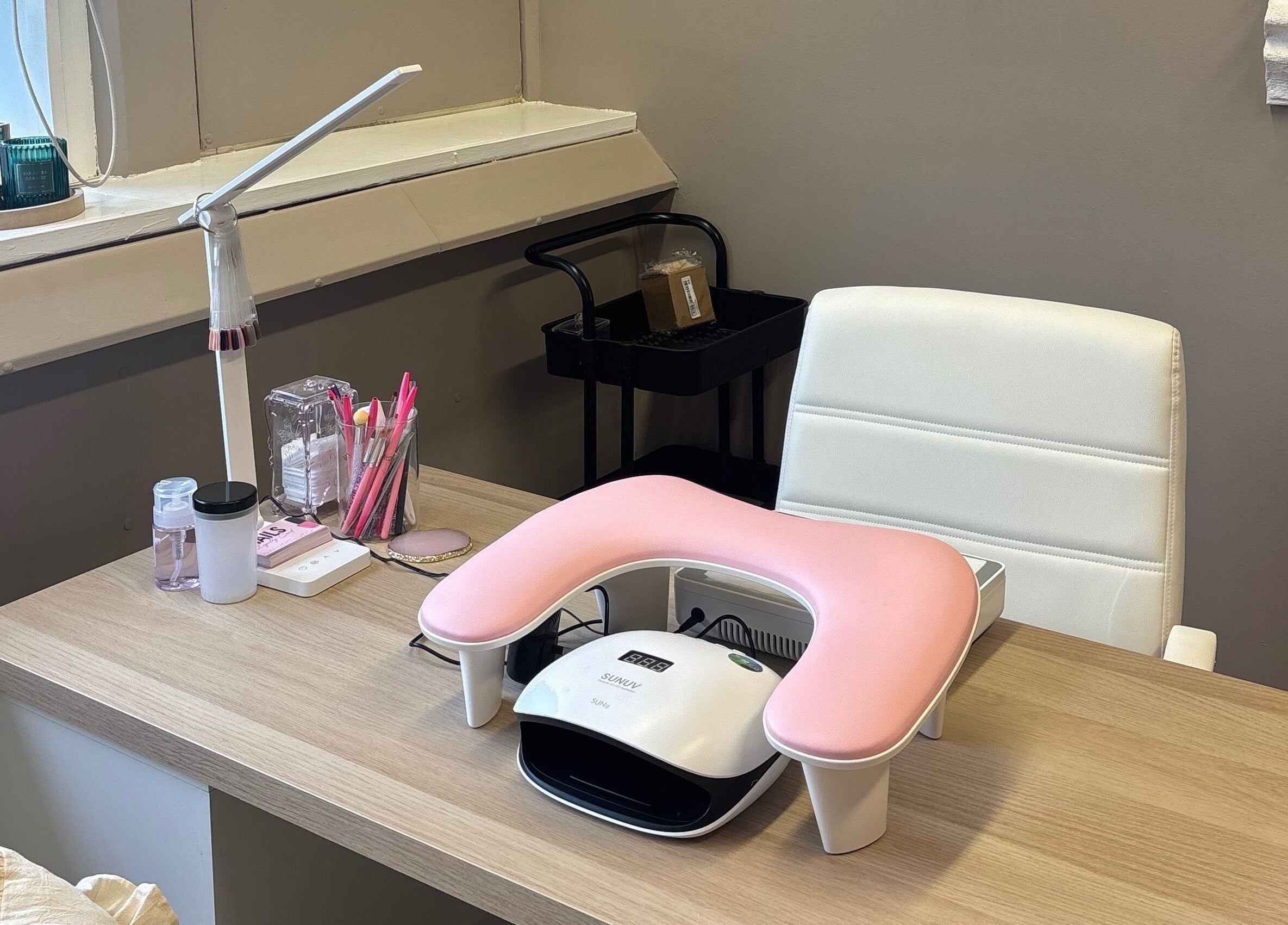 Nail station at Carved by Chloe in Livingston, Scotland, GB with tools and a white armchair.