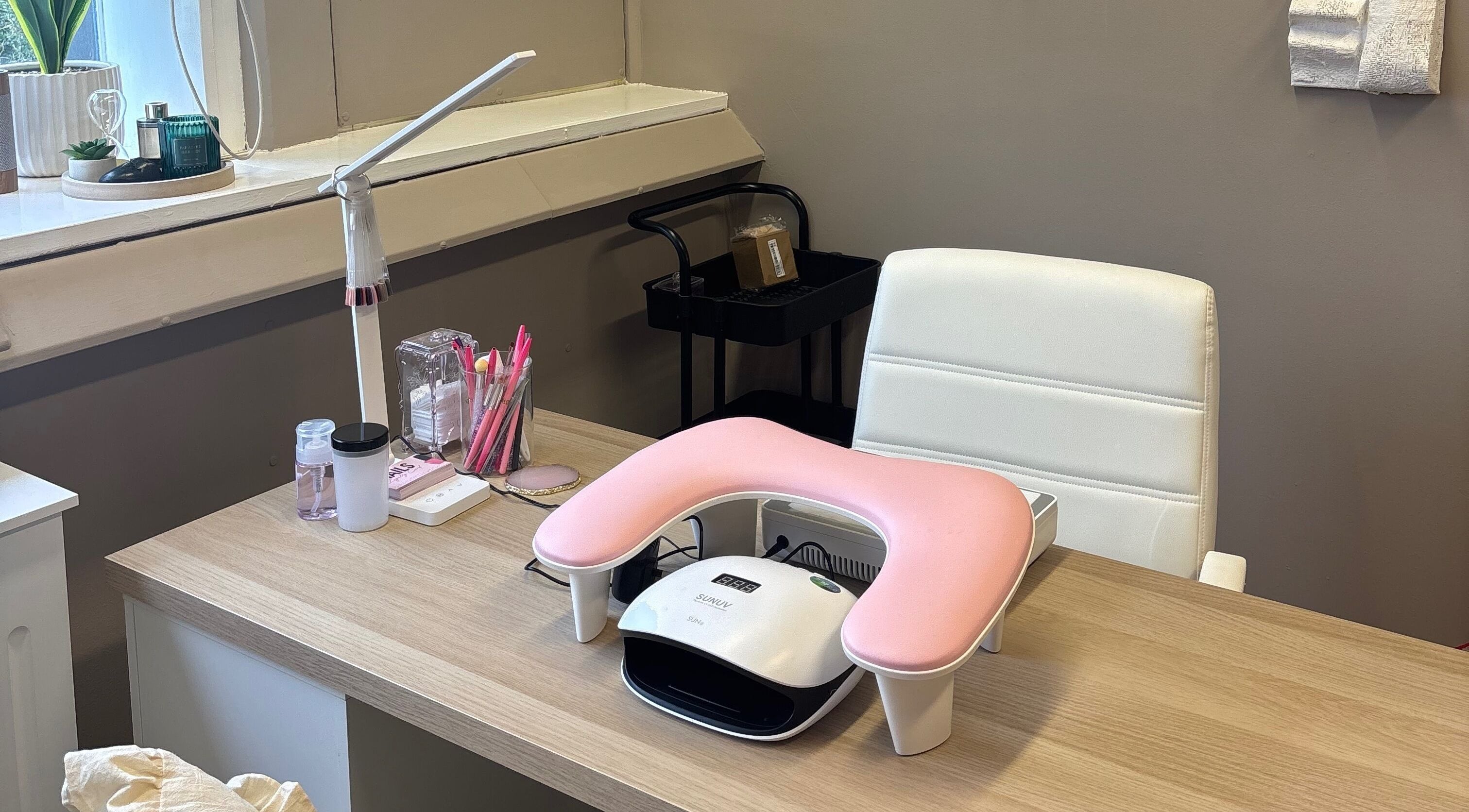 Nail station at Carved by Chloe in Livingston, Scotland, GB with tools and a white armchair.