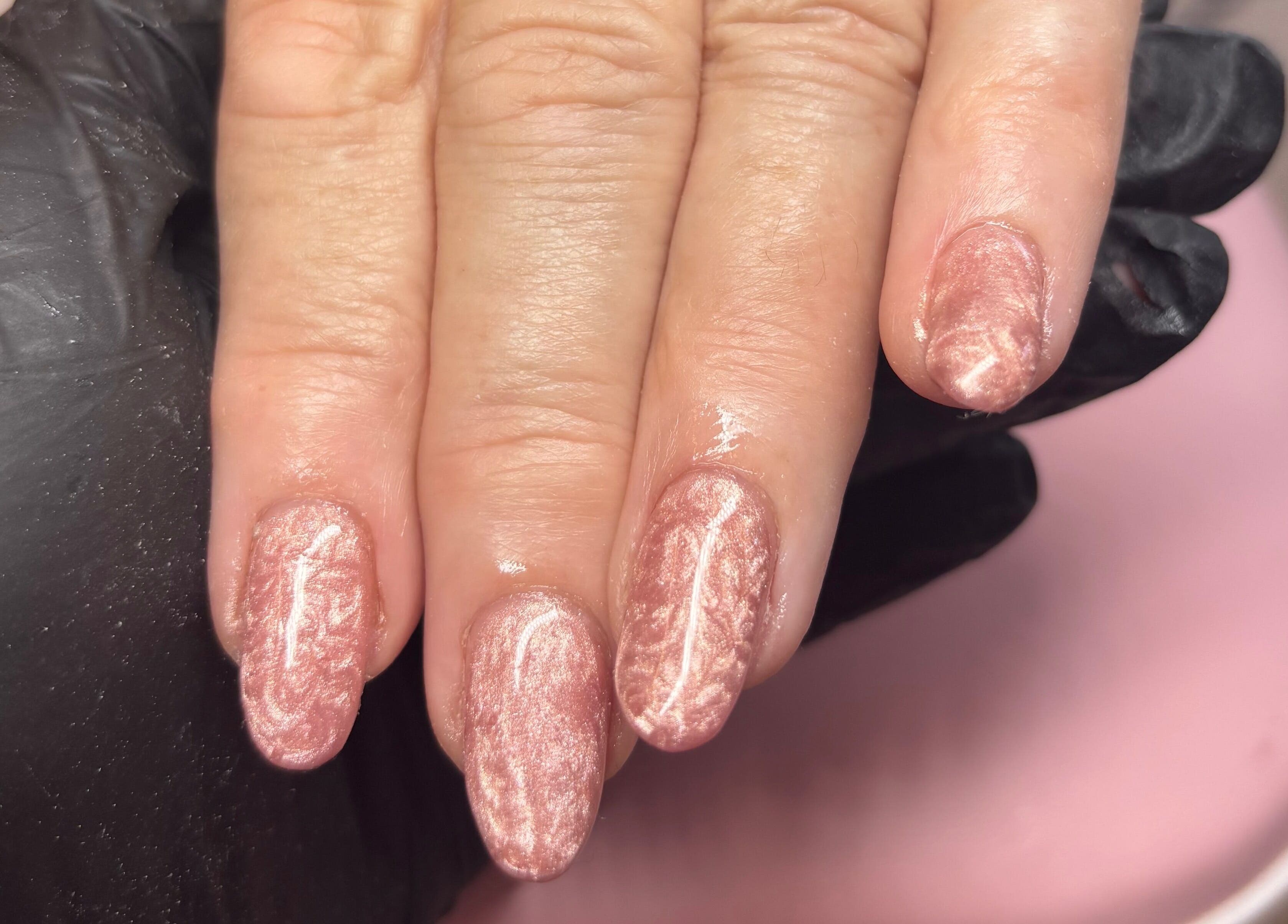 Beautiful manicured nails at Carved by Chloe, Livingston, Scotland, GB. Pink shimmer finish adds elegance.
