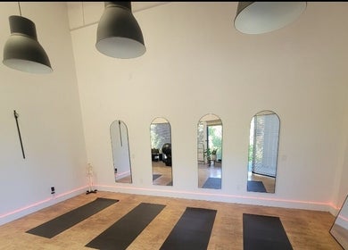 Elegant yoga studio at Core Essence, Sebastopol, California, US, featuring mirrors and yoga mats.