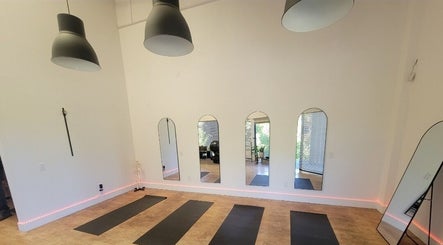 Elegant yoga studio at Core Essence, Sebastopol, California, US, featuring mirrors and yoga mats.