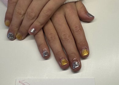 Elegant nail art with gold and silver at Nails By Corrina, Lethbridge Park, New South Wales, AU.