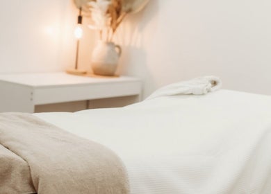 Calm massage room with warm lighting at Fleek Aesthetics, Mount Pleasant, Queensland, AU.