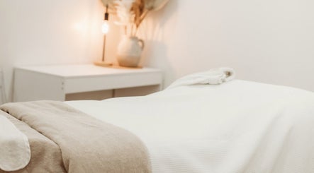 Calm massage room with warm lighting at Fleek Aesthetics, Mount Pleasant, Queensland, AU.