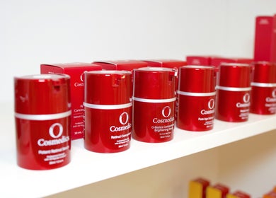 Red skincare products on shelf at Fleek Aesthetics, Mount Pleasant, Queensland, AU.