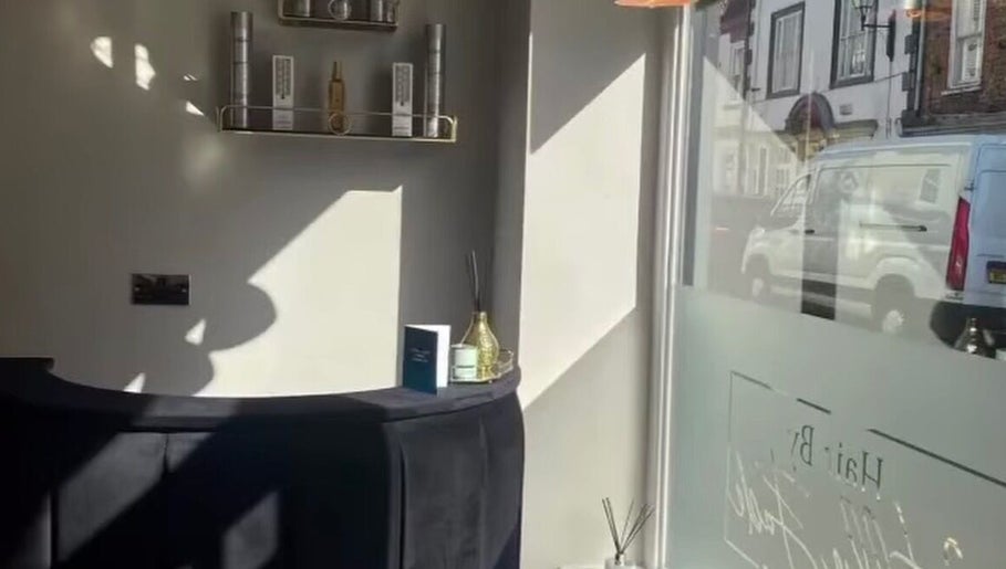 Sunlit interior of Charlotte Olivia Hair, Goole, England, highlighting sleek decor and elegant product display.