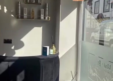 Sunlit interior of Charlotte Olivia Hair, Goole, England, highlighting sleek decor and elegant product display.