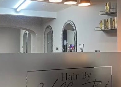 Entrance of Charlotte Olivia Hair in Goole, England featuring modern decor and elegant mirrors.