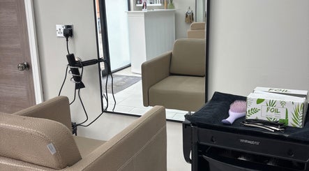Interior of Hairbyaliceemma salon in Derby, England, GB featuring a modern styling chair and a wall mirror.