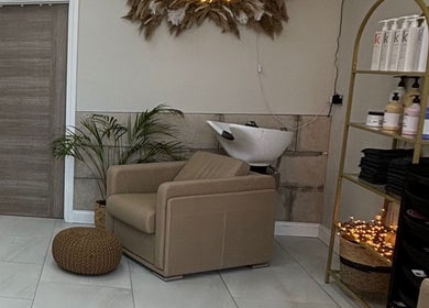 Relaxing salon chair setup at Hairbyaliceemma, Derby, England, GB, with stylish decor and hair products.