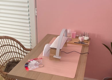 Cozy nail station at Lyndsay’s Beauty in Bottesford, England, GB, with pink decor and tools for perfect nails.