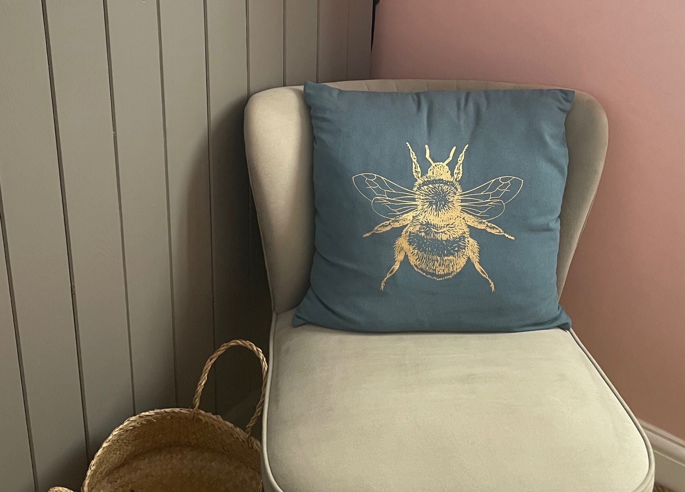 Comfy chair with bee cushion at Lyndsay’s Beauty, Bottesford, England, GB. Cozy corner decor.