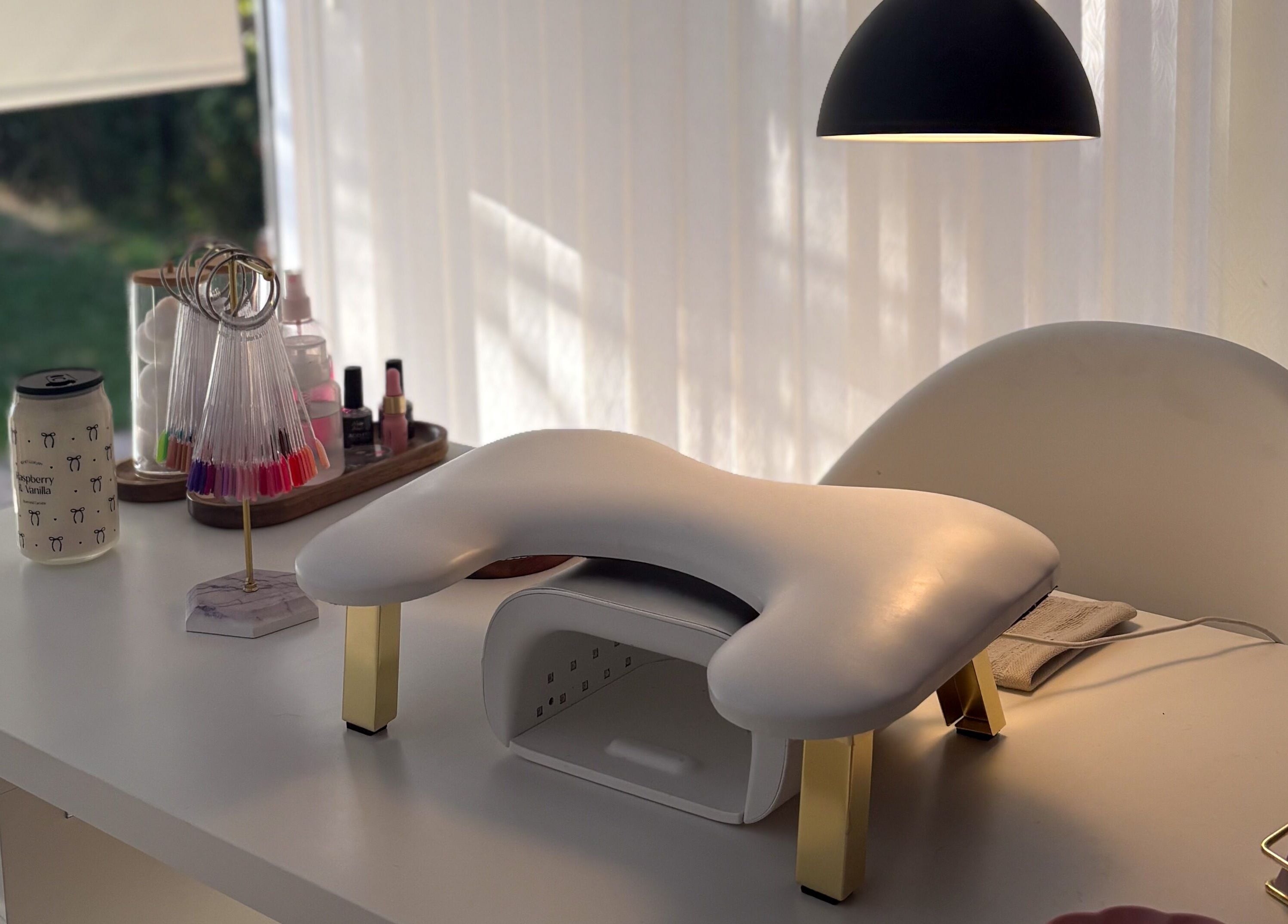 Manicure setup at Gels by Meg in Welshpool, Wales, GB showcasing polish displays and cozy atmosphere.